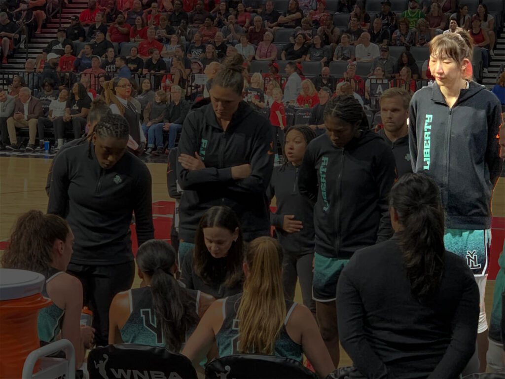 Tallest WNBA player in 2023 Han Xu standing in team huddle with the New York Liberty