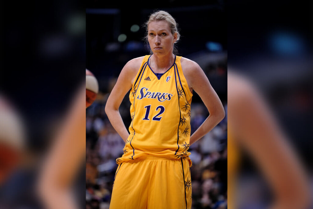 Margo Dydek stands on the court in a Los Angeles Sparks uniform.