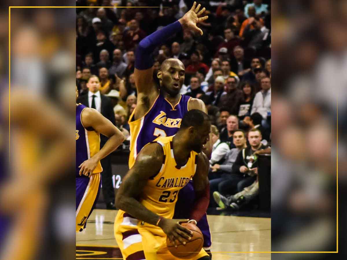 NBA player Kobe Bryant with the Los Angeles Lakers defends LeBron James during a game against the Cleveland Cavaliers.