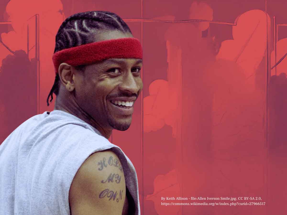 A photo of Allen Iverson looking over his shoulder and smiling, over a red background.