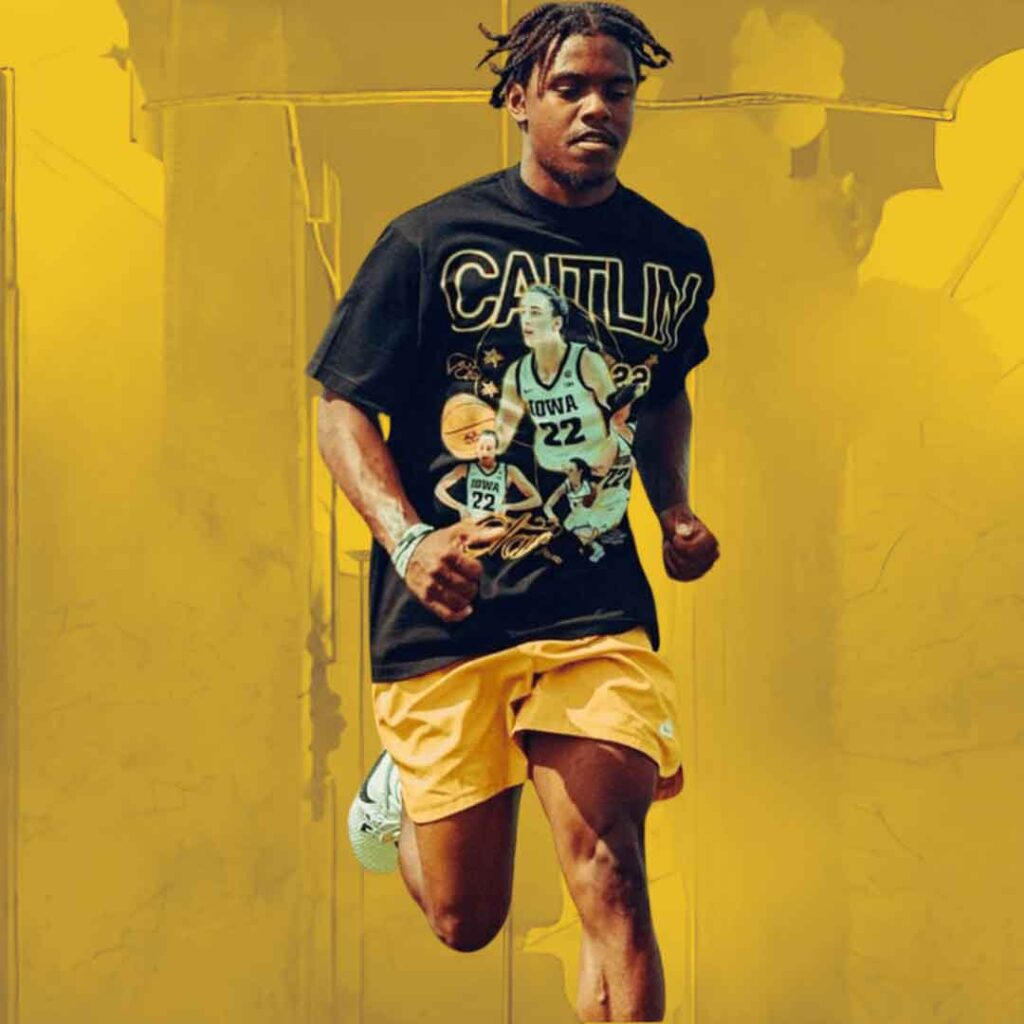A young man running in the Johan Dotson Vintage Caitlin Clark T-Shirt over a textured yellow background.