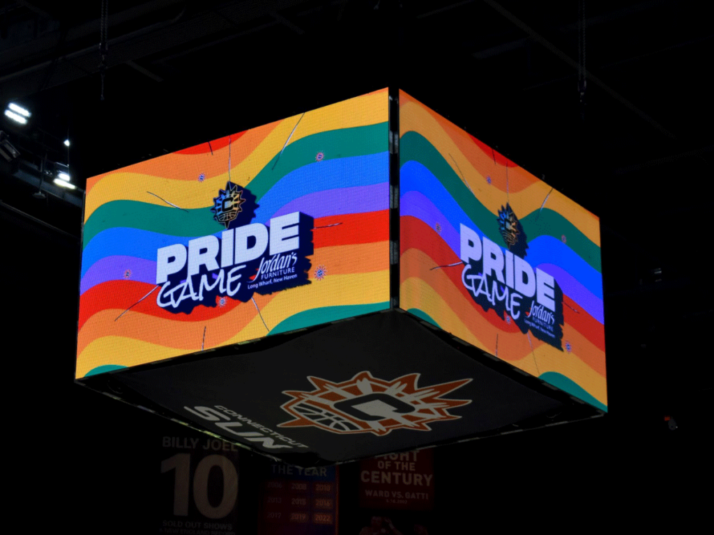 Pride Game signage displayed on the Connecticut Sun's center scoreboard.