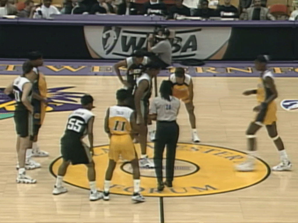 The 1997 Los Angeles Sparks and New York Liberty teams line up in preparation for a jump ball.